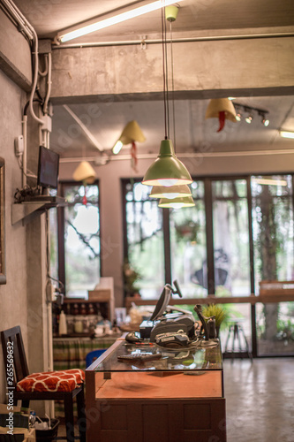 The background of a blurred counter  with a calculator  a barcode scanner  and a small tree placed on the table