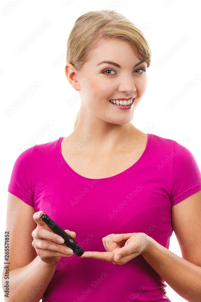 Woman using lancet on finger, checking and measuring sugar level Woman using lancet on finger, checking and measuring sugar level