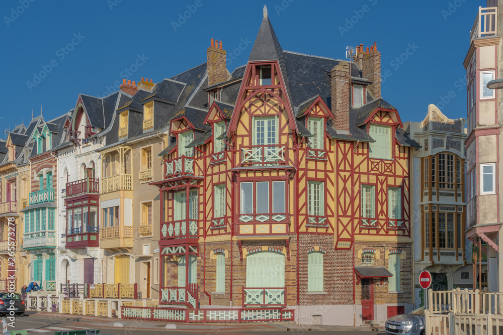 Fototapeta premium Mers-Les-Bains, France - 04 29 2019: Along the dike at sunset