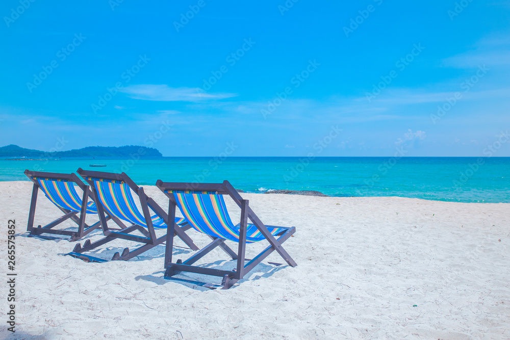 Beach chairs with sea and bright sky
