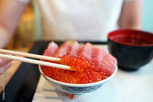 Otoro, ikura and uni donburi - Japanese rice bowl topped with fresh tuna, sea urchin roe, salmon roe, Japanese traditional food. photo