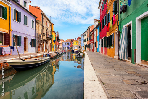 Colourfully painted house facade on Burano island, province of Venice, Italy © martinhosmat083