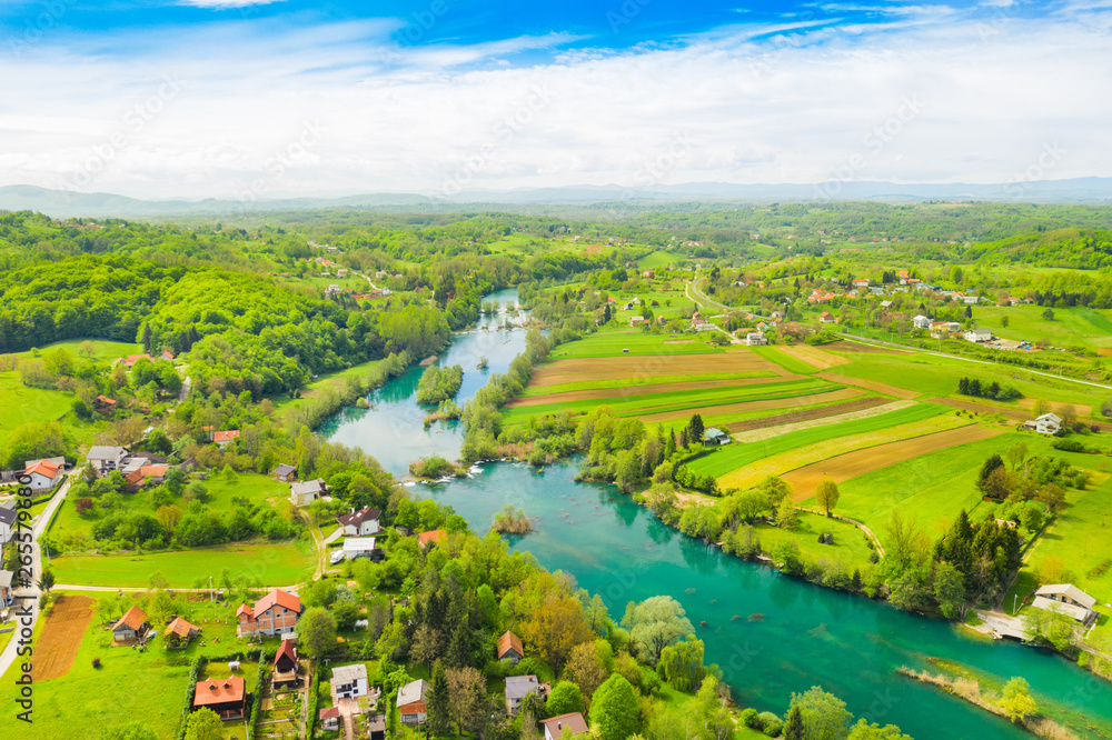 Croatia, green countryside, Mreznica river from air, panoramic view of Belavici village, waterfalls in spring, popular tourist destination