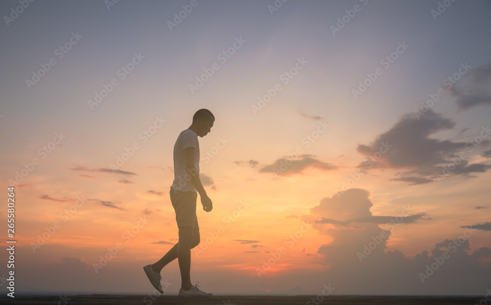 raveler young man walking in the summer mountains at sunset and enjoying view of nature.