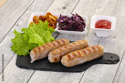 Grilled sausages served mushrooms and cabbage