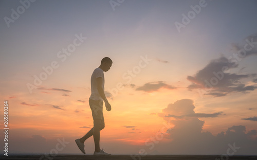 Fototapeta Naklejka Na Ścianę i Meble -  raveler young man walking in the summer mountains at sunset and enjoying view of nature.