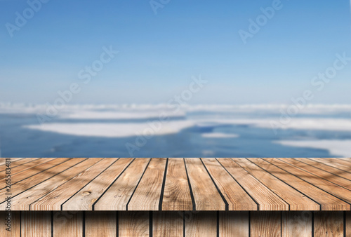 old wooden table place with snow place winter background