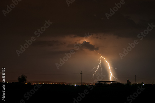 Branched lightning bolt strikes in the city of Tirgu Mures, Romania during an active springtime thunderstorm