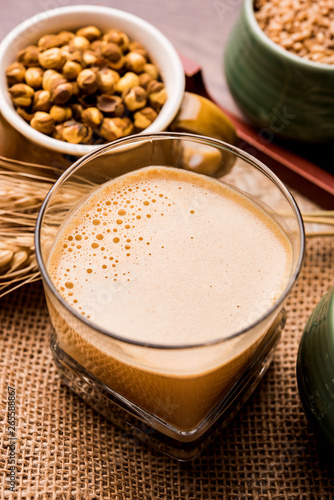 Sattu sharbat is a cooling sweet drink made in summer with roasted black chickpea flour  barley  suger  salt   water. served in a glass. selective focus