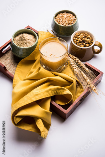 Sattu sharbat is a cooling sweet drink made in summer with roasted black chickpea flour, barley, suger, salt & water. served in a glass. selective focus photo