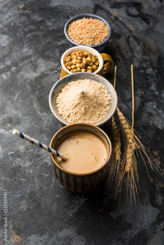 Sattu sharbat is a cooling sweet drink made in summer with roasted black chickpea flour, barley, suger, salt & water. served in a glass. selective focus photo