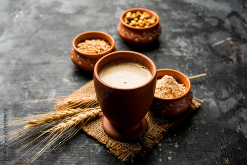 Sattu sharbat is a cooling sweet drink made in summer with roasted black chickpea flour, barley, suger, salt & water. served in a glass. selective focus photo