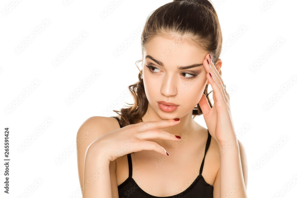 Young woman with makeup, posing on white background Young woman with makeup, posing on white background