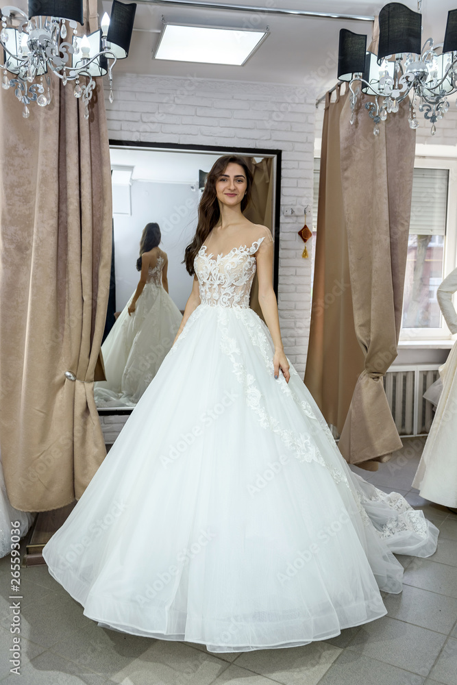 Young smiling bride posing in wedding dress Young smiling bride posing in wedding dress