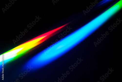 Abstract colorful spectrum in darkness. Colorful rays of light.