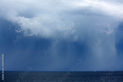 Wild storm over the ocean and sailing boat