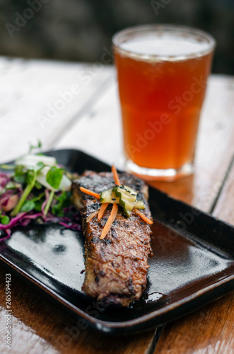 marinated grilled barbecue pork rib with salad