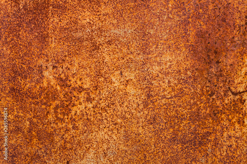 Bright red-orange iron sheet. Rust compound is an iron oxide. Deep rust, oxide and corrosion texture on a metal surface.