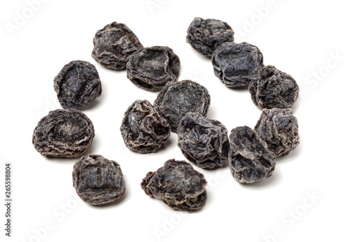 Dried black plums isolated on white background