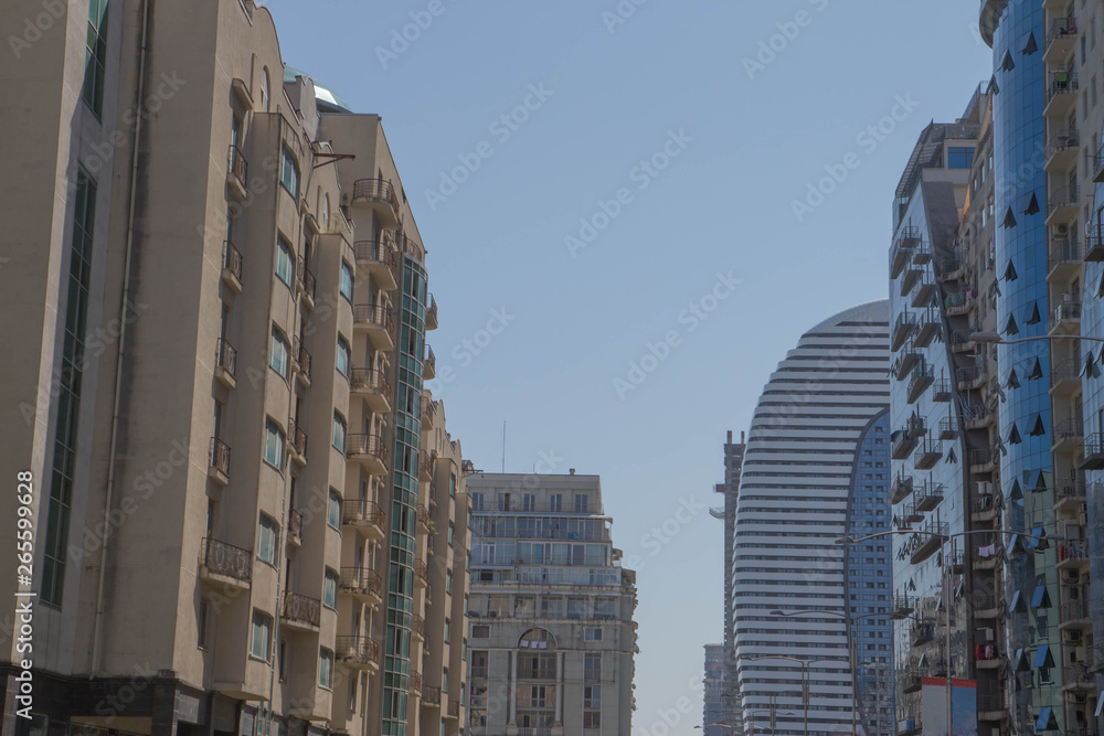 Modern silhouettes of skyscrapers in the city. Facade of a modern apartment building