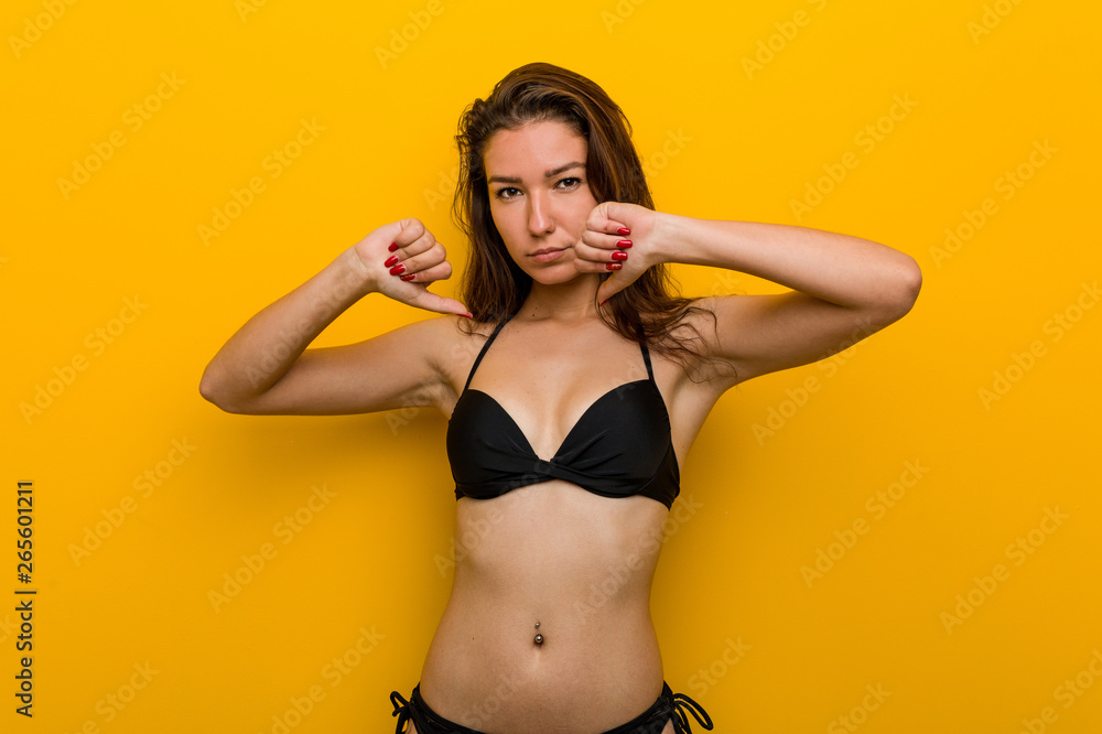 Young european woman wearing bikini feels proud and self confident, example to follow. Young european woman wearing bikini feels proud and self confident, example to follow.