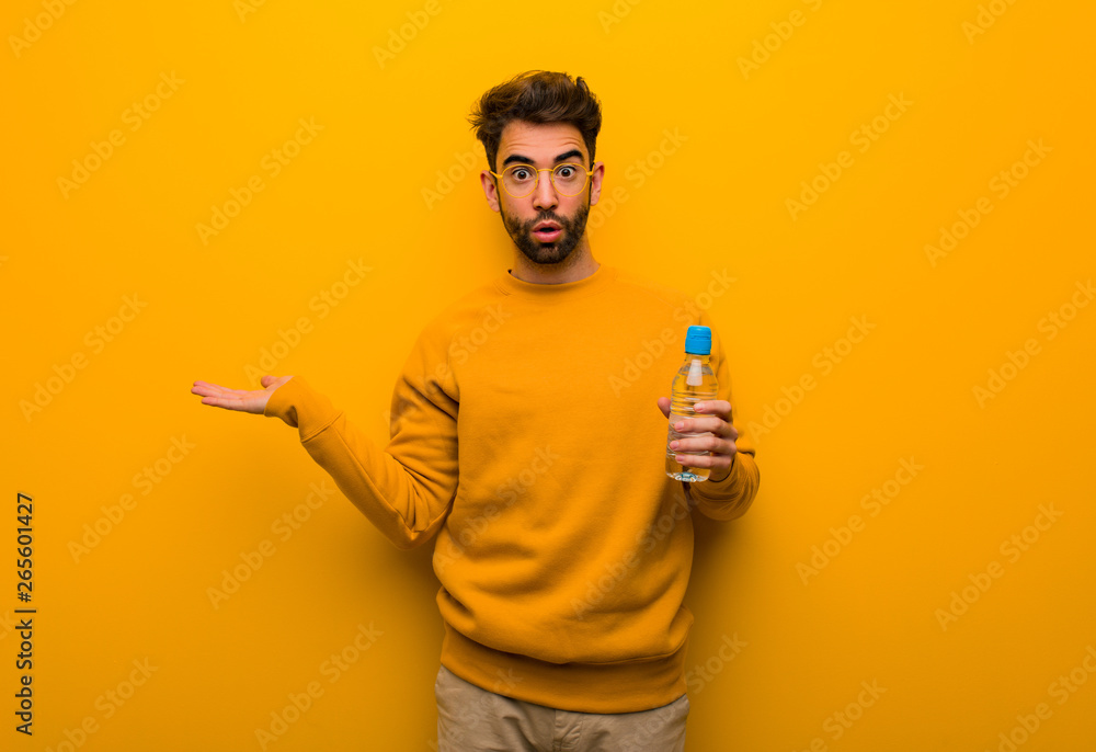 Young man holding something on palm hand Young man holding something on palm hand