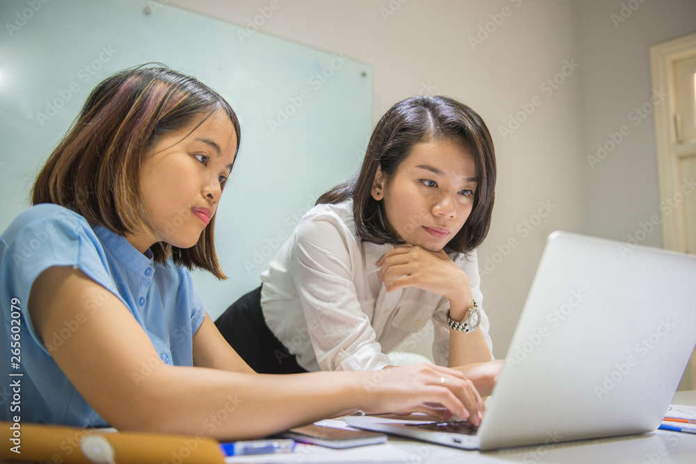 Office worker discuss about information on laptop Office worker discuss about information on laptop