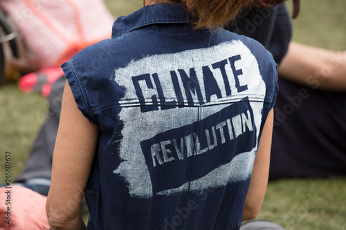 Photography A climate change protestor wearing a top with climate revolution painted on