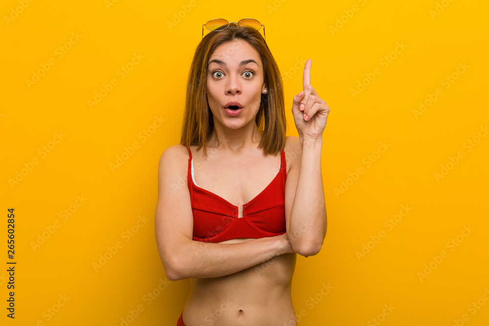 Young caucasian woman wearing bikini and sunglasses having some great idea, concept of creativity. Young caucasian woman wearing bikini and sunglasses having some great idea, concept of creativity.