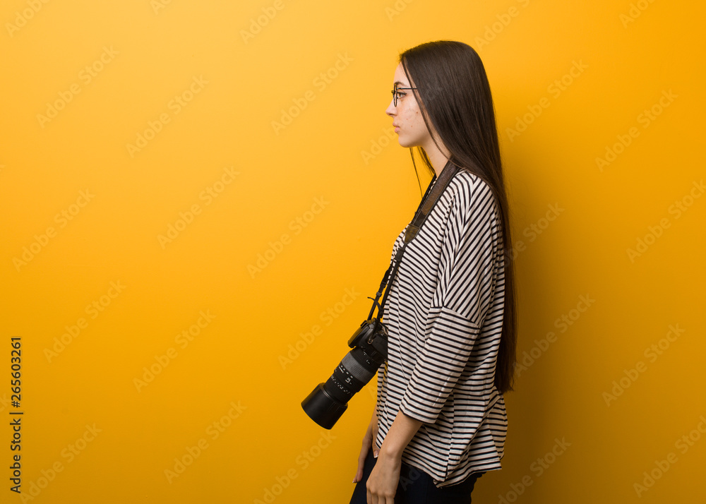 Young photographer woman on the side looking to front Young photographer woman on the side looking to front