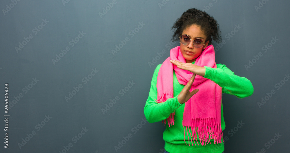 Young african american girl with blue eyes doing a timeout gesture Young african american girl with blue eyes doing a timeout gesture
