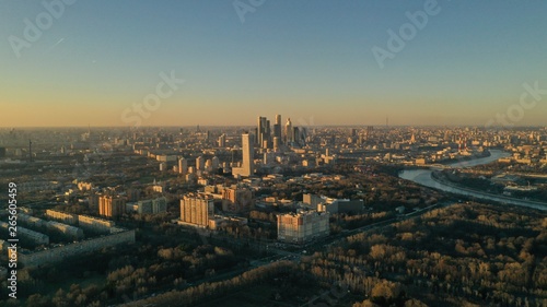 Aerial view of Moscow city glass skyscrapers and Moscow river. Cars driving on the motorway. Sunny, blue sky, spring. Russia. Modern. Urban.