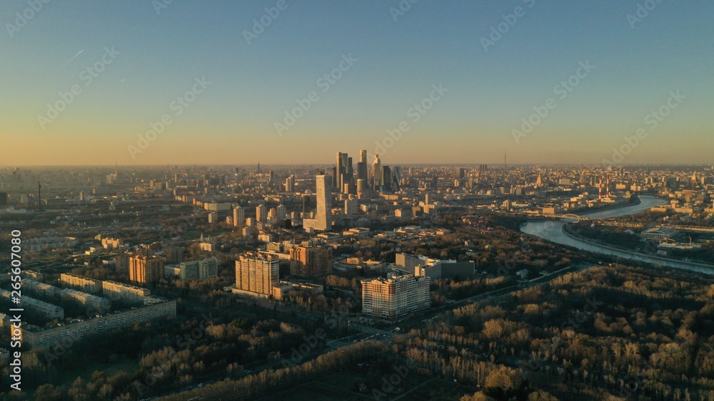 Aerial view of Moscow city glass skyscrapers and Moscow river. Cars driving on the motorway. Sunny, blue sky, spring. Russia. Modern. Urban.