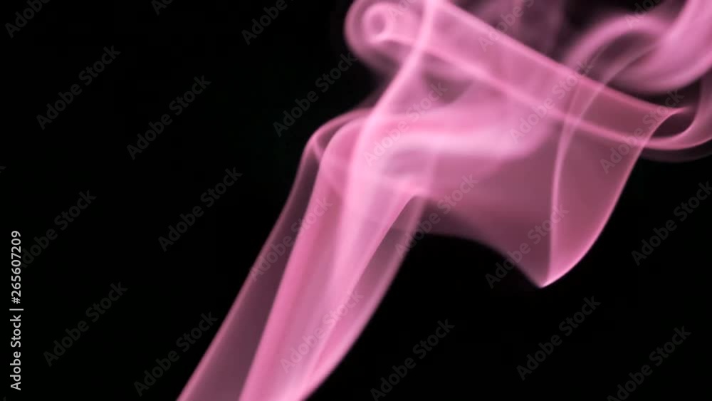 Thin trickle of bright neon pink smoke slowly rising graceful twists up on black background. Colored smoke blowing from bottom to top. Closeup Thin trickle of bright neon pink smoke slowly rising graceful twists up on black background. Colored smoke blowing from bottom to top. Closeup