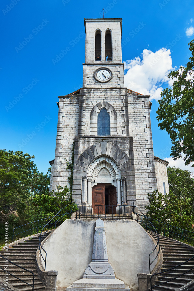 A stone church with a monument with the names of the heroes of the First World War.in Balazuc, France.