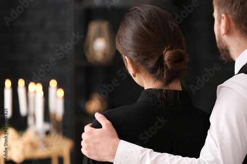 Couple pining after their relative at funeral photo