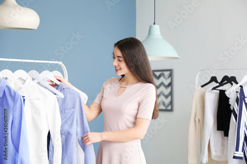 Young woman choosing clothe...