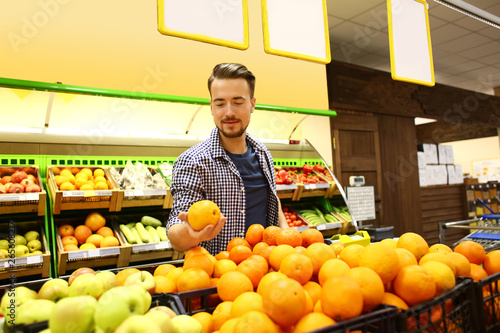 Young man choosing food in ...