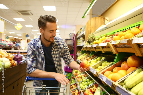 Young man choosing food in ...