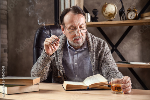 Handsome mature man reading...