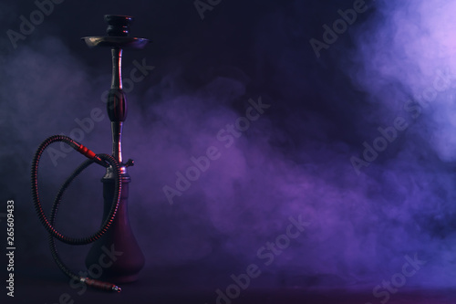 Hookah with fume on dark background