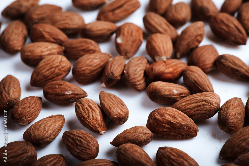 Almond on white background close up. Raw Natural Organic Almonds Nuts Scattered. Healthy Food for Life Natural Light Selective Focus Almond on white background close up. Raw Natural Organic Almonds Nuts Scattered. Healthy Food for Life Natural Light Selective Focus