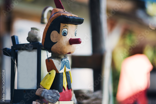 Canvas Print A colorful and abandoned Pinocchio with a Japanese lamp on its back