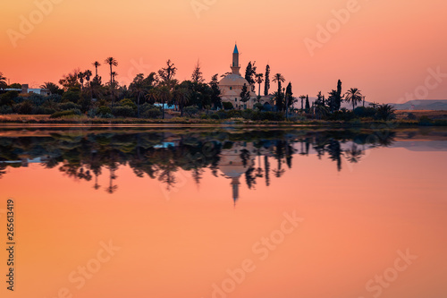 The ancient mosque Hala Sultan Tekkes on the shore of the salt lake in Larnaca, Cyprus during the sunset