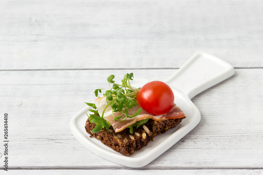 Sandwich with bacon, tomato and herbs sprouts. Sandwich with bacon, tomato and herbs sprouts.