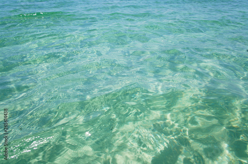 Transparent clean sunny ocean sea water waves for background and texture.