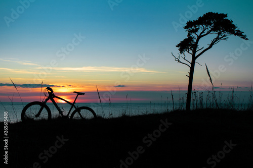 beautiful sunset on the sea and the silhouette of a bicycle