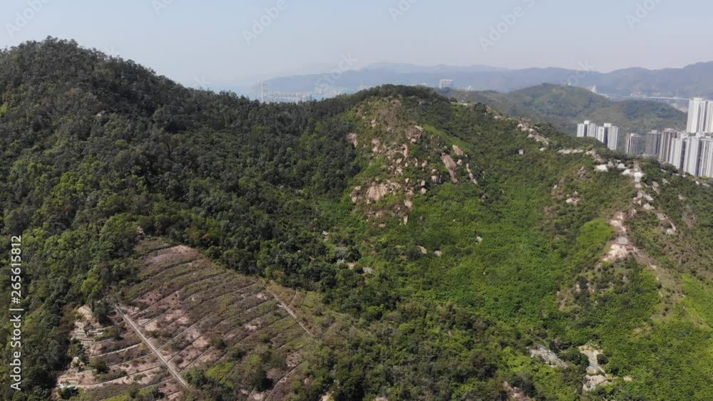 Green mountains of Tsing Yi island, aerial shot, camera fly forward ...