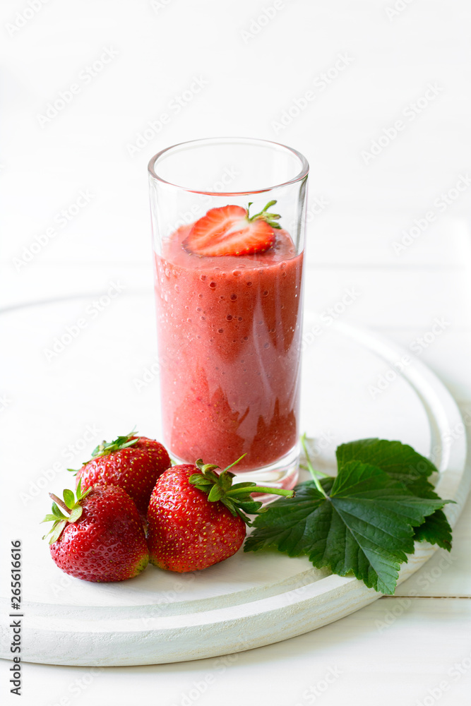 Strawberry and banana smoothie glass on white wooden background. Detox and healthy eating concept Strawberry and banana smoothie glass on white wooden background. Detox and healthy eating concept
