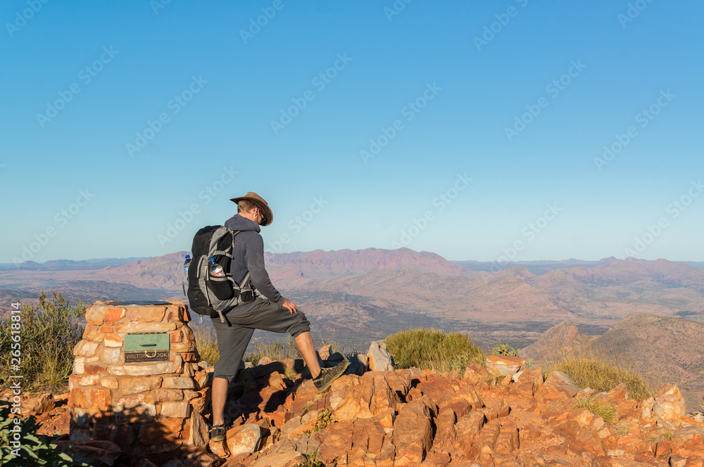 man enjoying view after a hike to the top of Mount Sonder just outside Alice Springs, West MacDonnel National Park, Australia man enjoying view after a hike to the top of Mount Sonder just outside Alice Springs, West MacDonnel National Park, Australia